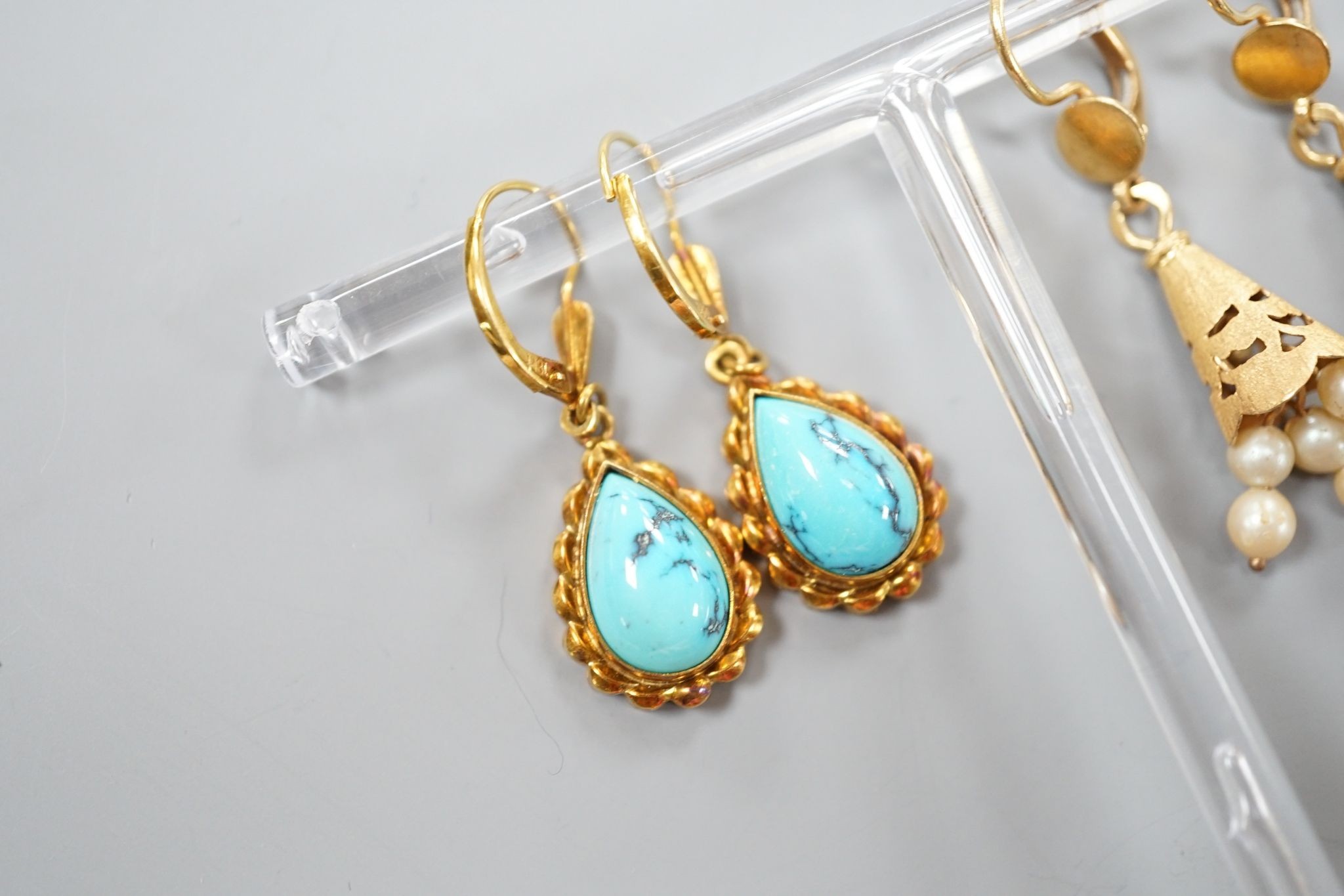 Two modern pairs of 18ct and gem set drop earrings, one with cultured pearl, 42mm and one with turquoise, gross weight 11.7 grams.